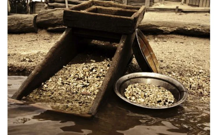 sepia-gold-panning-apparatus-by-stream