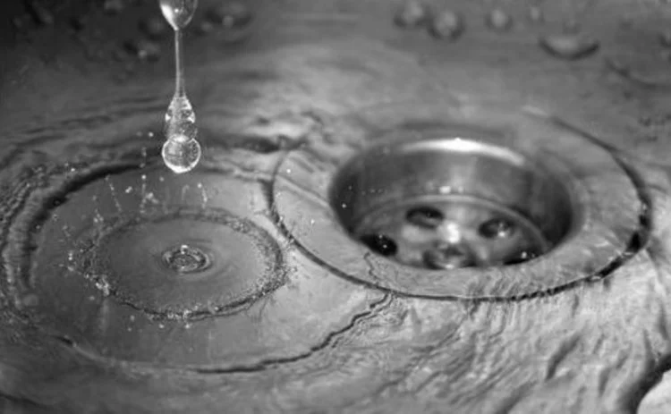 water-dripping-into-sink-and-down-plughole-closeup
