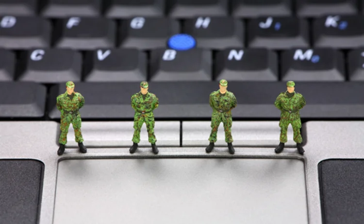 Toy soldiers on keyboard representing cyber security