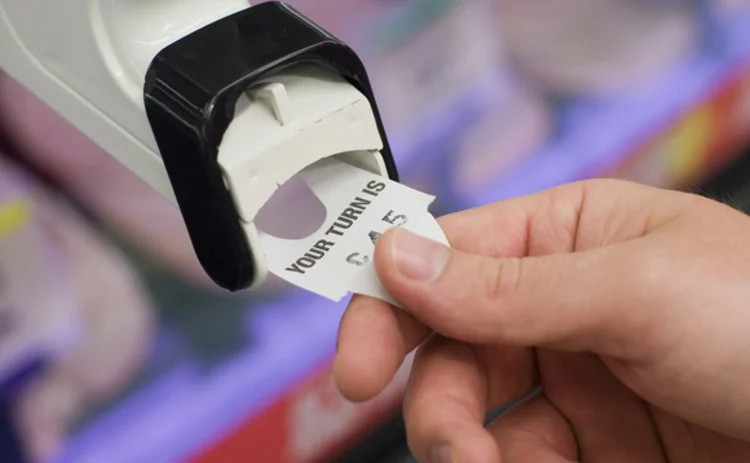 pulling-a-ticket-from-a-deli-counter