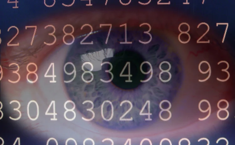 An eye in close-up superimposted by a screen of random numbers
