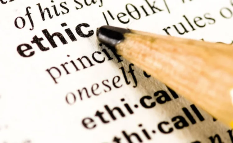A pencil pointing at the word 'ethic' in a dictionary