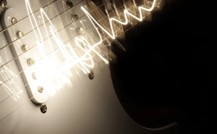 close-up-of-electric-guitar-with-white-lit-strings