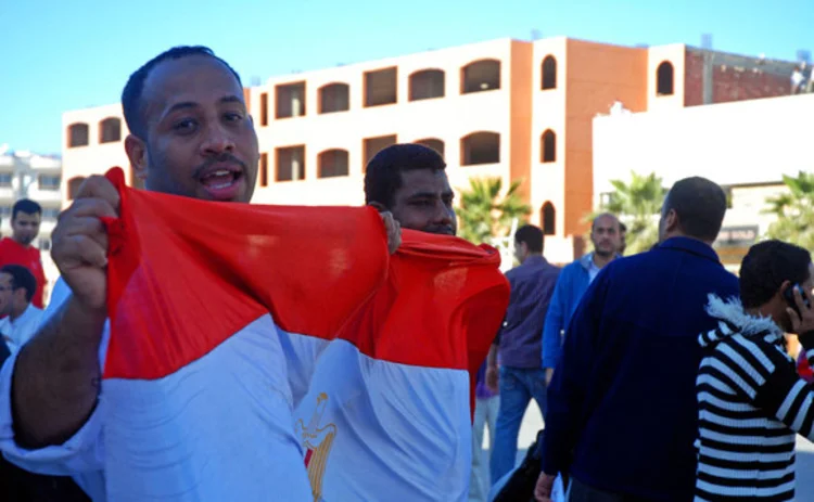 A man holding an Egypt flag during a demonstration