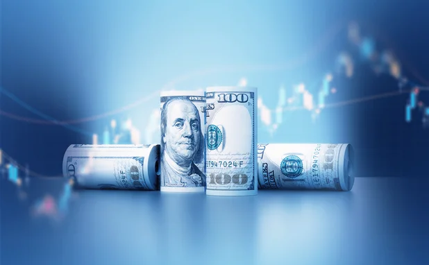 Rolled up American dollar banknotes over financial graph