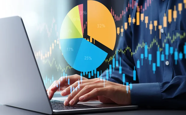 A segmented pic chart superimposed over a person’s hands on a keyboard