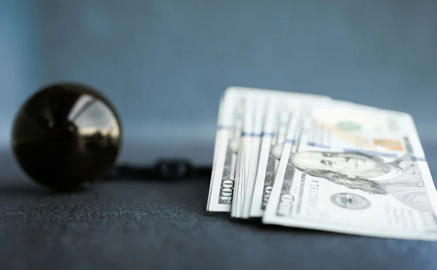 Dollars with ball and chain
