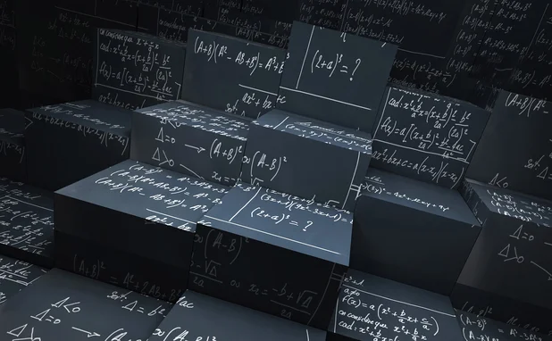Blackboard blocks with mathematical formulas written in chalk all over them 