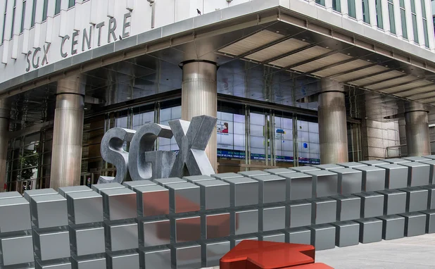 Metallic computerised wall repelling a red arrow, superimposed in front of the SGX building in Singapore