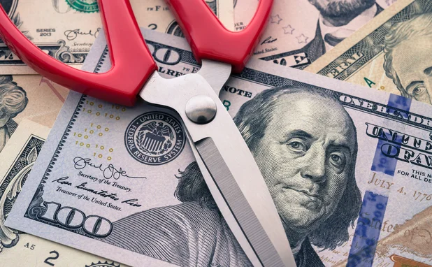 Scissors on top of US dollars