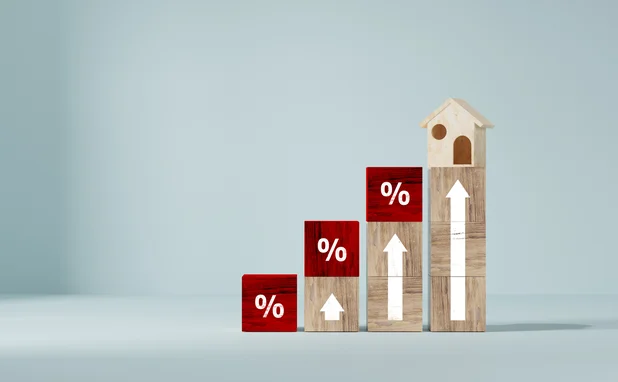 Ascending wooden blocks with up arrows and percentage signs and a house at the top