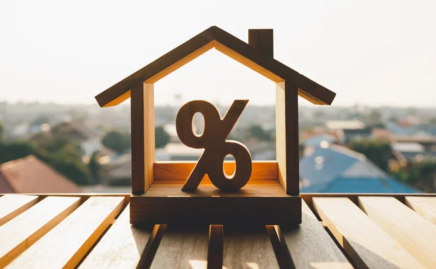 Model of a house containing a percentage sign
