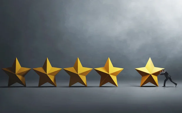 Businessperson pushes a 3D rendition of a star next to four others, to create a five-star review