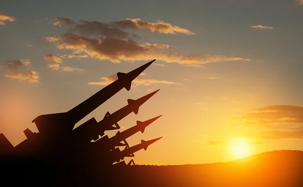 Sunset silhouette of missiles aimed into the sky