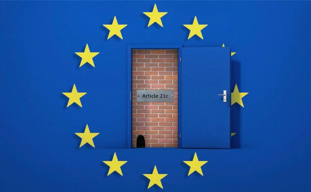 A brick wall behind a door has been broken down