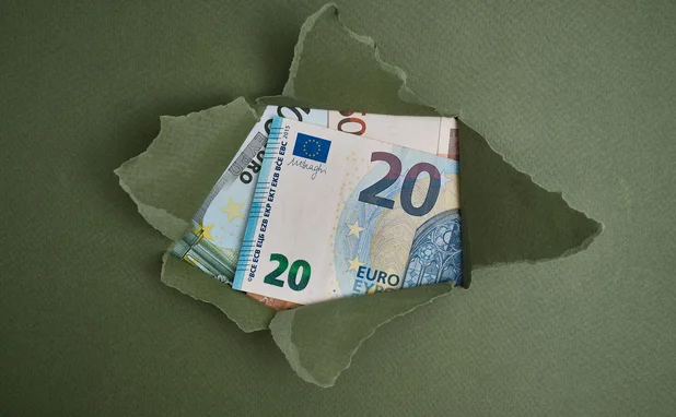 A paper package has been ripped open, revealing euro notes 