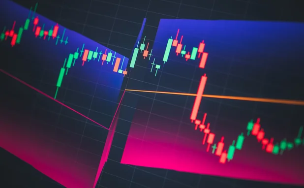 Candlestick chart showing volatility on tech-themed dark background
