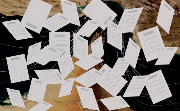 Exam papers fly randomly in front of a backdrop of the strait of hormuz
