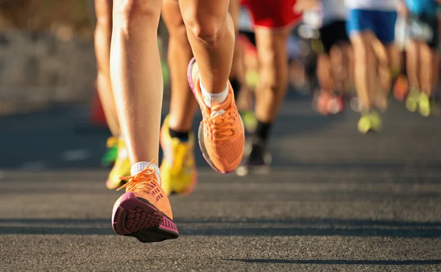 A photo of runners’ legs in a marathon