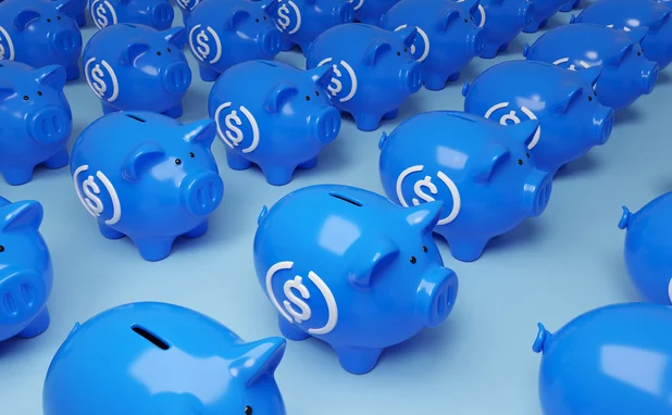 Blue, stablecoin-labelled piggy banks 