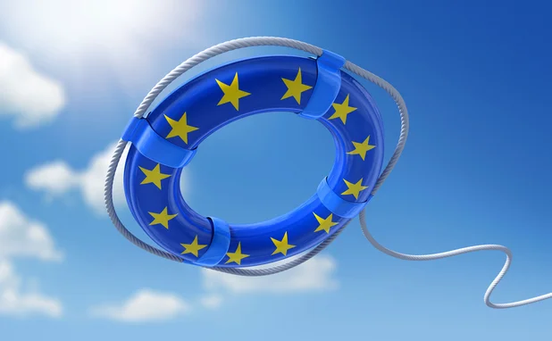 A life belt with the EU flag styling on it is being thrown into the water
