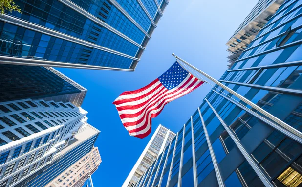 US flag and skyscrapers