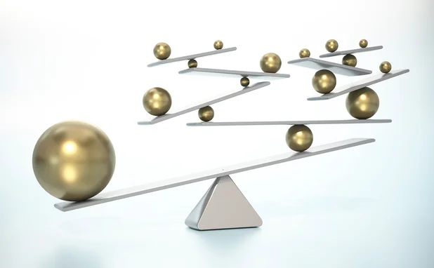 Large golden ball outweighing numerous smaller golden balls on the other side of a seesaw