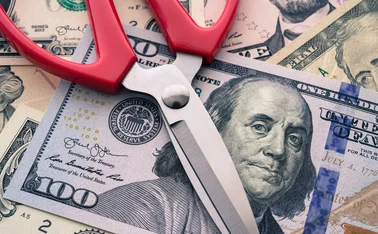 Scissors on top of US dollars