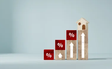 Ascending wooden blocks with up arrows and percentage signs and a house at the top