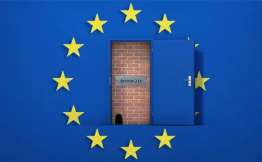 A brick wall behind a door has been broken down