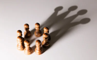 Pawns creating shadows of a crown