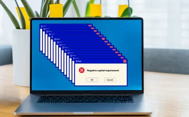 Error message on a laptop screen reads ‘negative capital requirement’