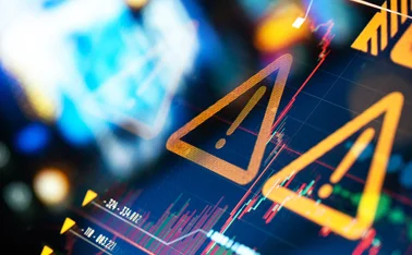 Warning signs over background of erratic chart data on a screen