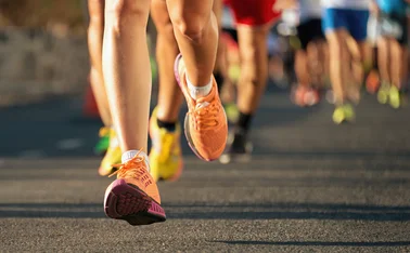 A photo of runners’ legs in a marathon