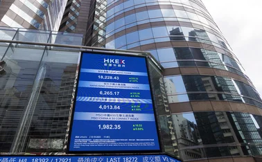 Hong Kong Stock Exchange building behind electronic information board