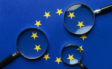 Three magnifying glasses scrutinise the EU flag