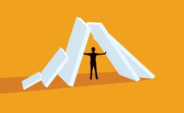 Illustration of a man holding up some falling structures