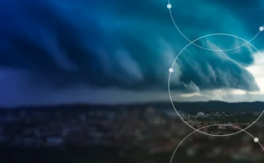 Storm clouds over a city illustrating physical climate risk and extreme weather