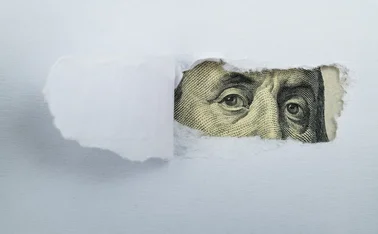 Torn white paper revealing US Currency - stock photo
