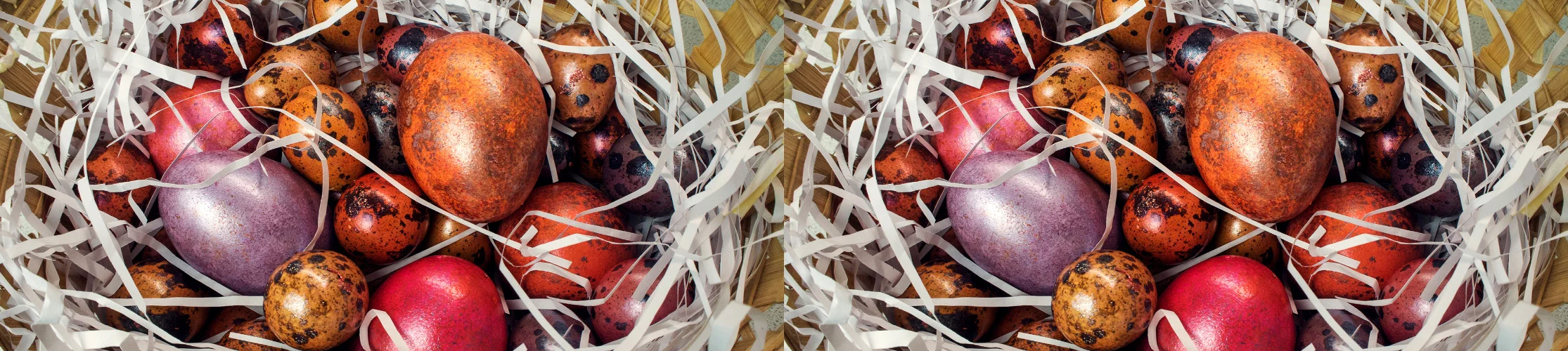 Chicken and quail eggs covered in metallic paint in a basket