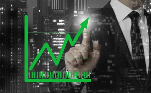 A businessman points at a high result reading on a chart