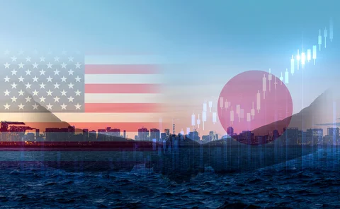 A handshake between US and Japan participants against Tokyo skyline backdrop