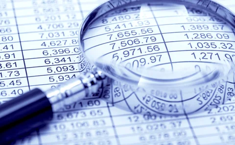 Financial-statement and magnifying glass