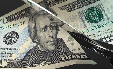 Scissors cut a US $20 bill