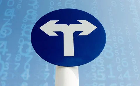 Sign displaying opposite paths  in front of cascading identifier data