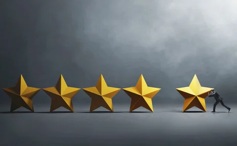 Businessperson pushes a 3D rendition of a star next to four others, to create a five-star review
