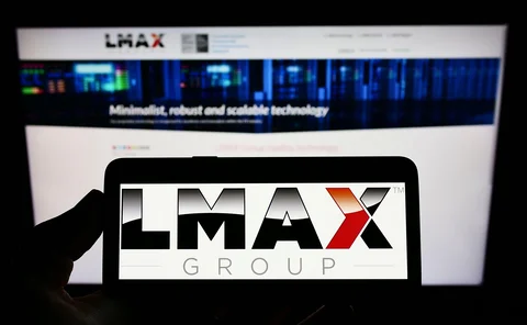 Mobile phone and computer screen with LMAX logo and website