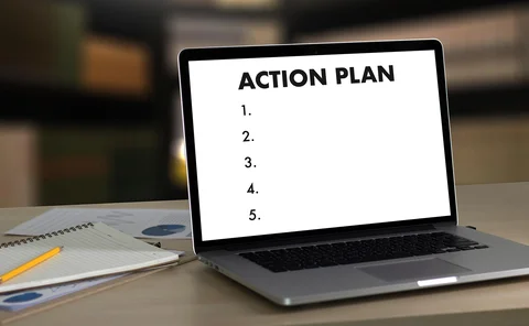 Laptop screen shows the header ‘action plan’ and underneath lists five action points, none of which contain text