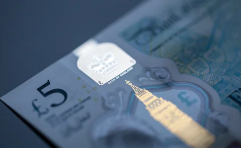 Five pound note highlighting Bank of England text