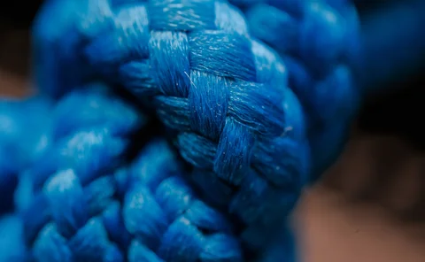 Close-up of blue woven textile fibres showing intricate threads and texture